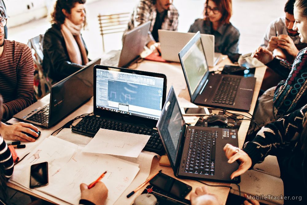 desk with multiple computers being utilized