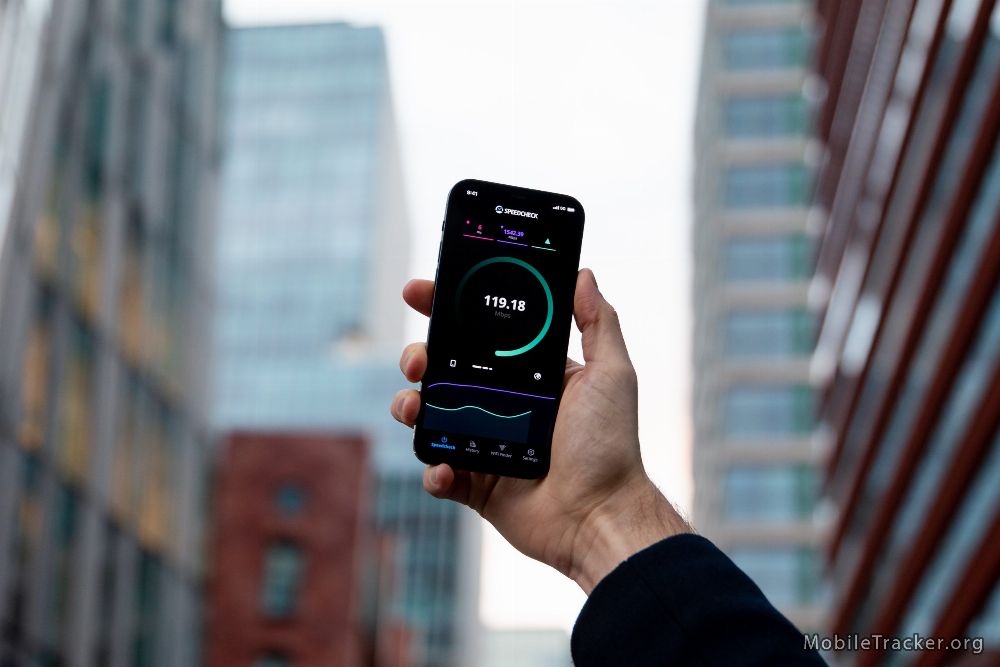 hand holding a phone while measuring cellular network speed